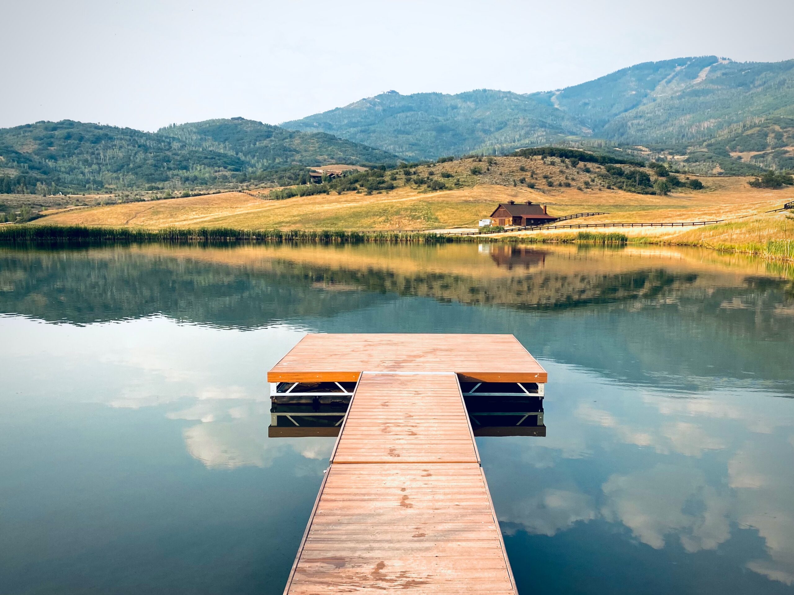 A wooden dock extends out onto a peaceful lake at Steamboat Springs