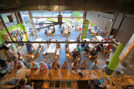 Above view of a lively brewery scene with people enjoying their drinks.