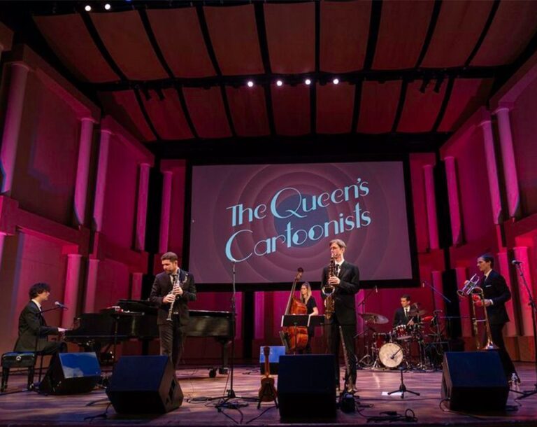 The Queen's Cartoonists play their instruments on stage