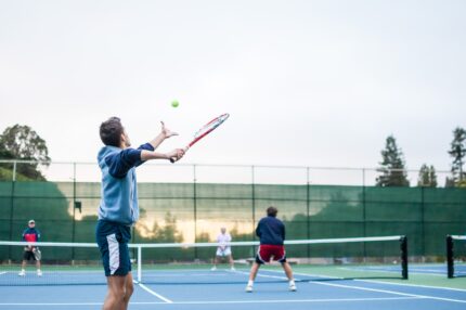 Four people play tennis
