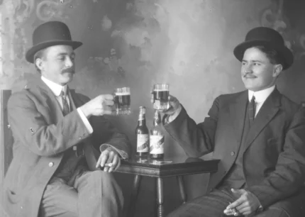 A black and white vintage image of two men drinking beer