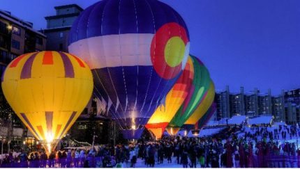 Six hot air balloons on the ground on a snowy day