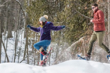 Two people happily snowshoeing