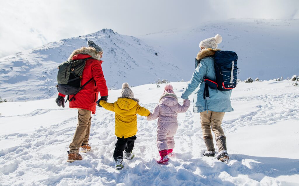 A family surrounded by snowy mountains