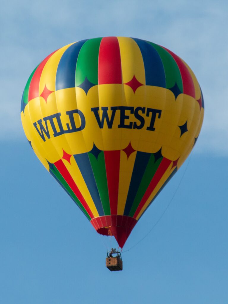 The Wild West balloon flying against a clear blue sky