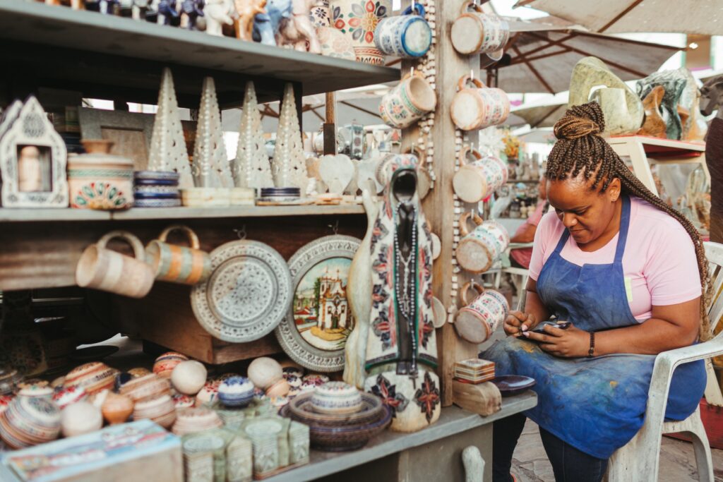 A woman working at a ceramics market stall