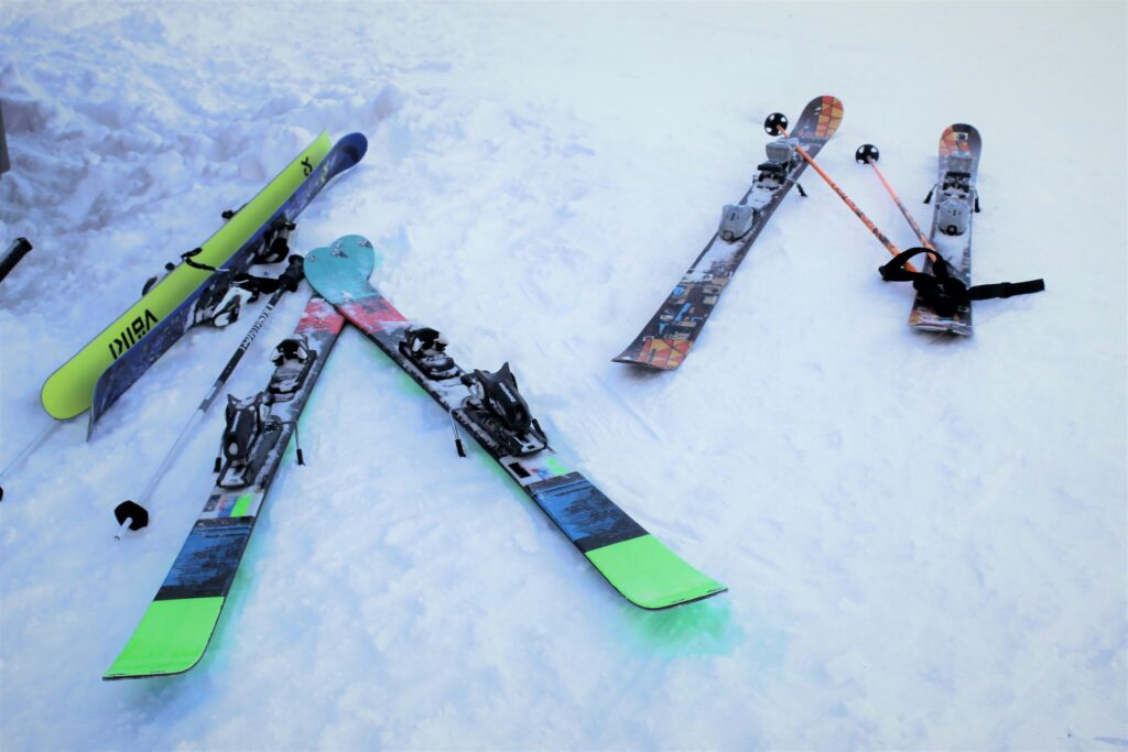 Three pairs of skis in the snow
