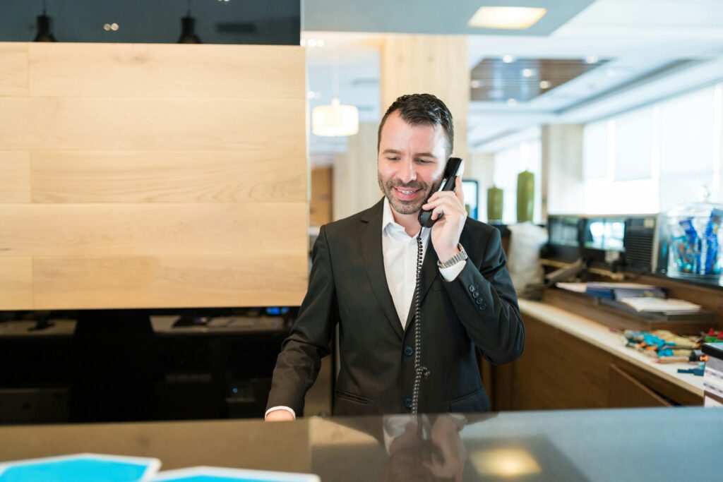 Concierge staff using a telephone