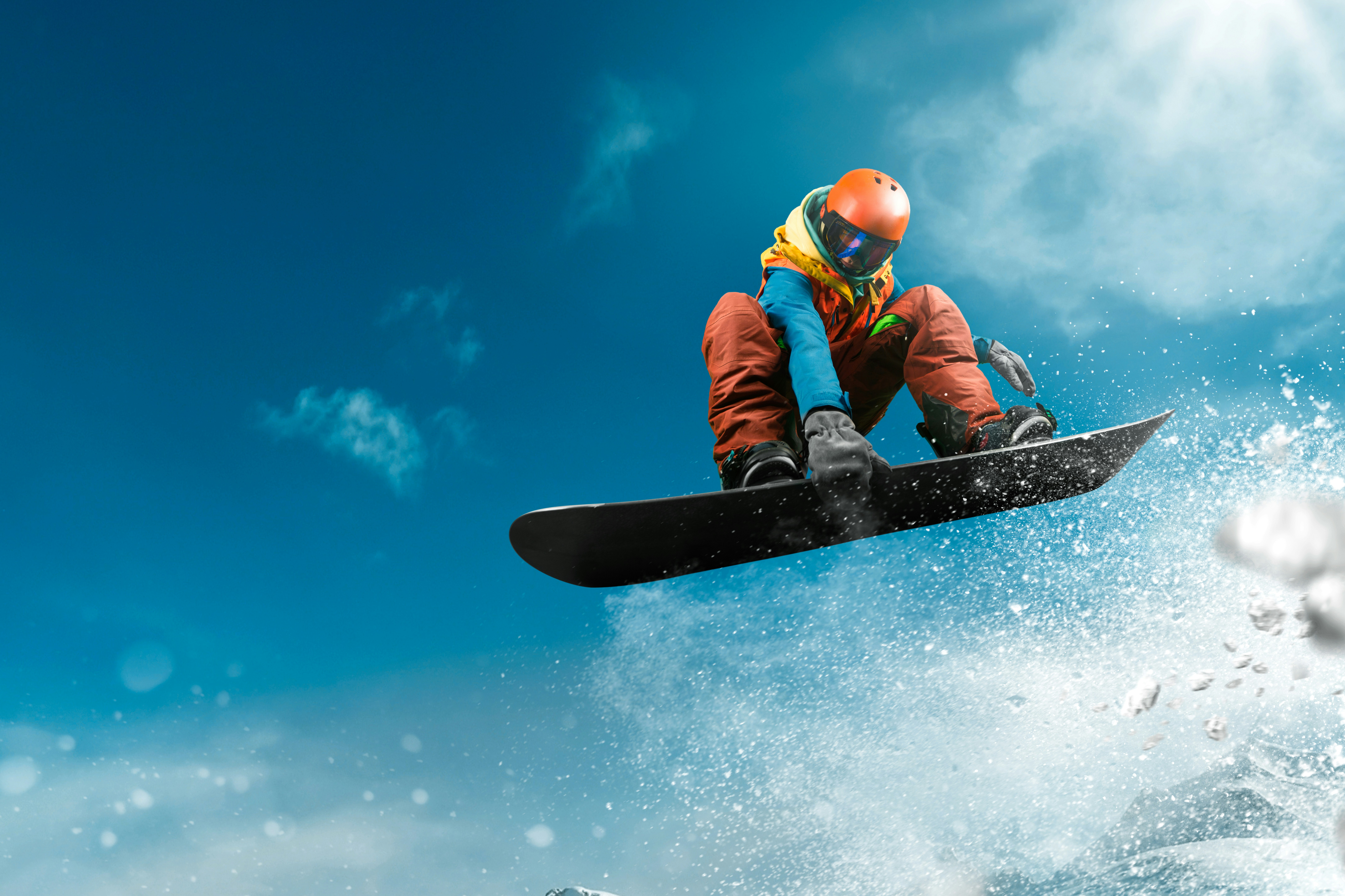 A snowboarder flying through the sky