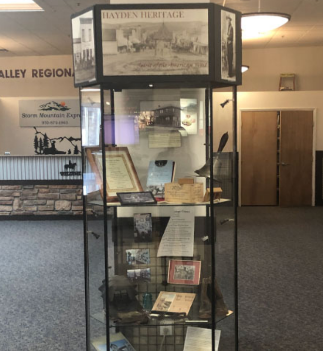 A glass cabinet at Yampa Valley Airport filled with historical arteacts