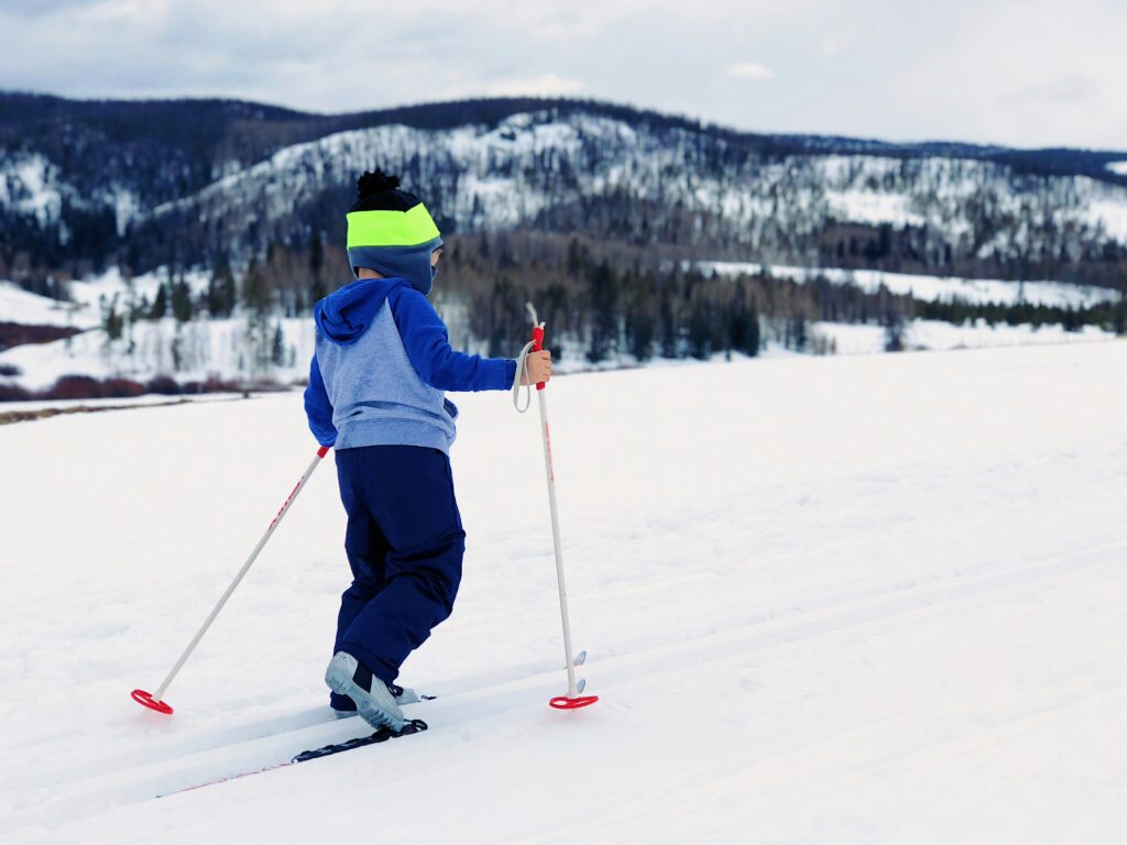 A child on skis walks away