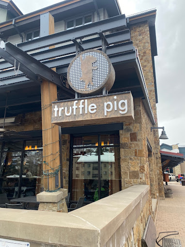 The Truffle Pig exterior sign, with the logo of a dancing pig