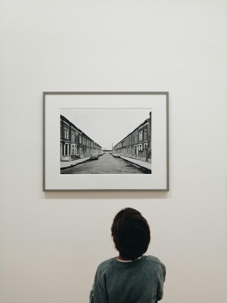 A child looks up at a black and white photograph