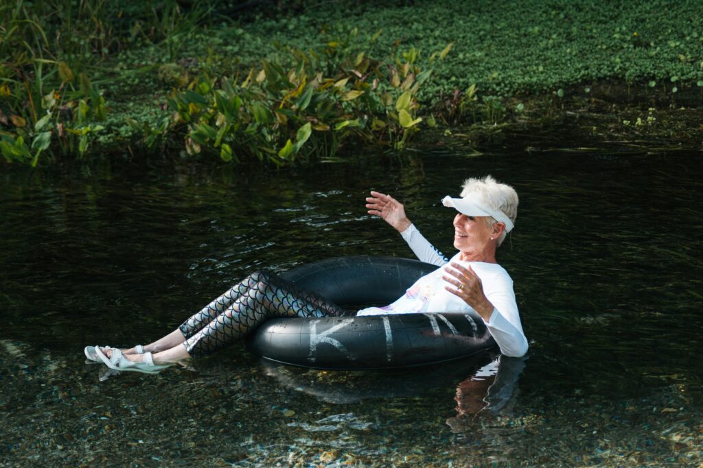 A woman gently drifting along a river sat on a round rubber tube