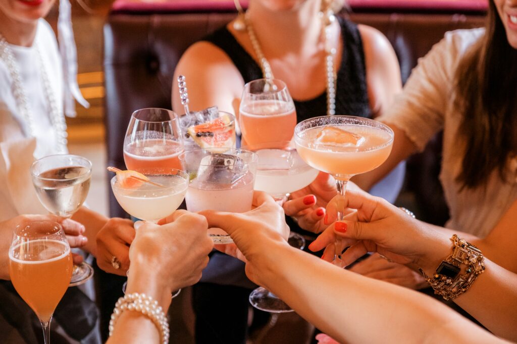 A group of women clinking cocktail glasses