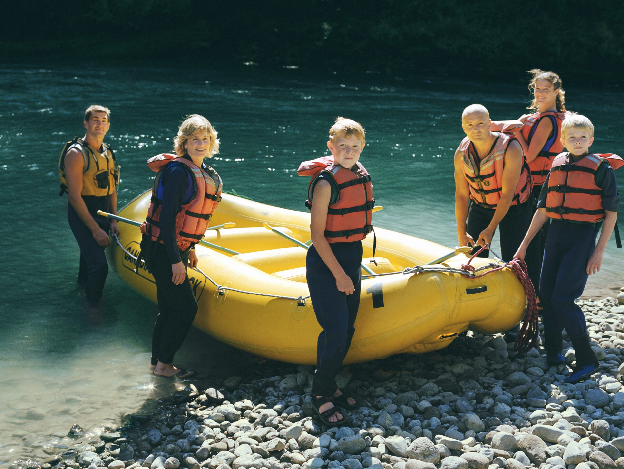 A family surrounding a water raft