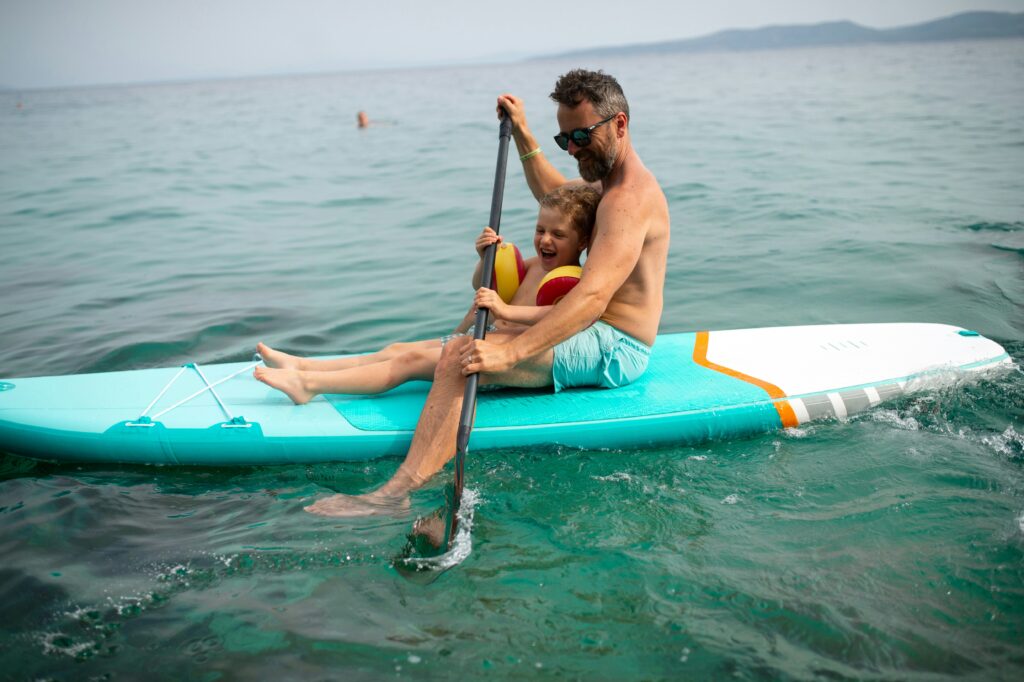 A father and child on a paddle board