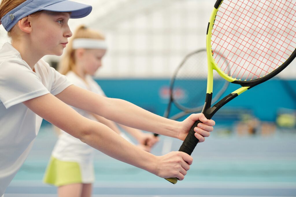 Two children playing tennis