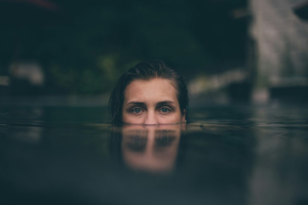 A woman swimming in a dark pool