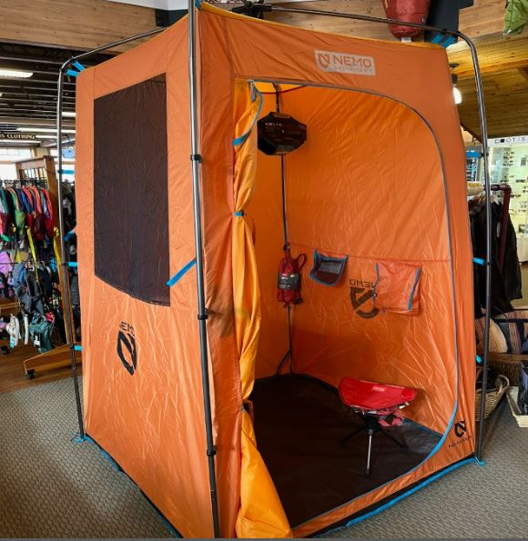 An orange Heliopolis privacy cabin stocked at Ski Haus