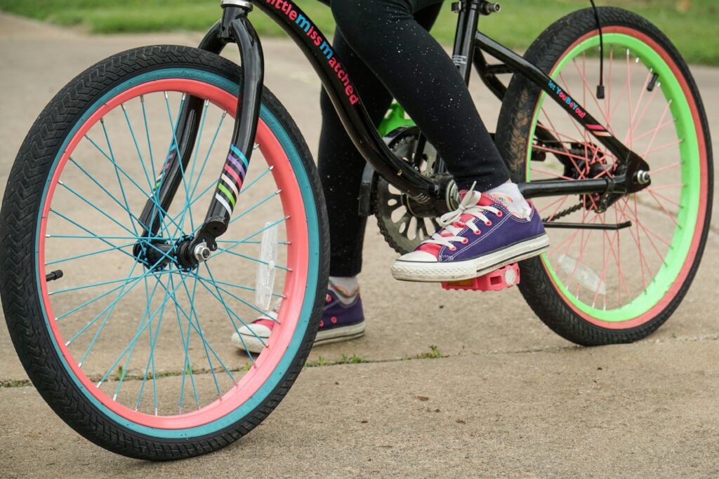 The feet of a child riding a bike