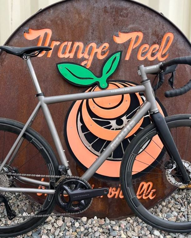 A bike infront of the Orange Peel logo