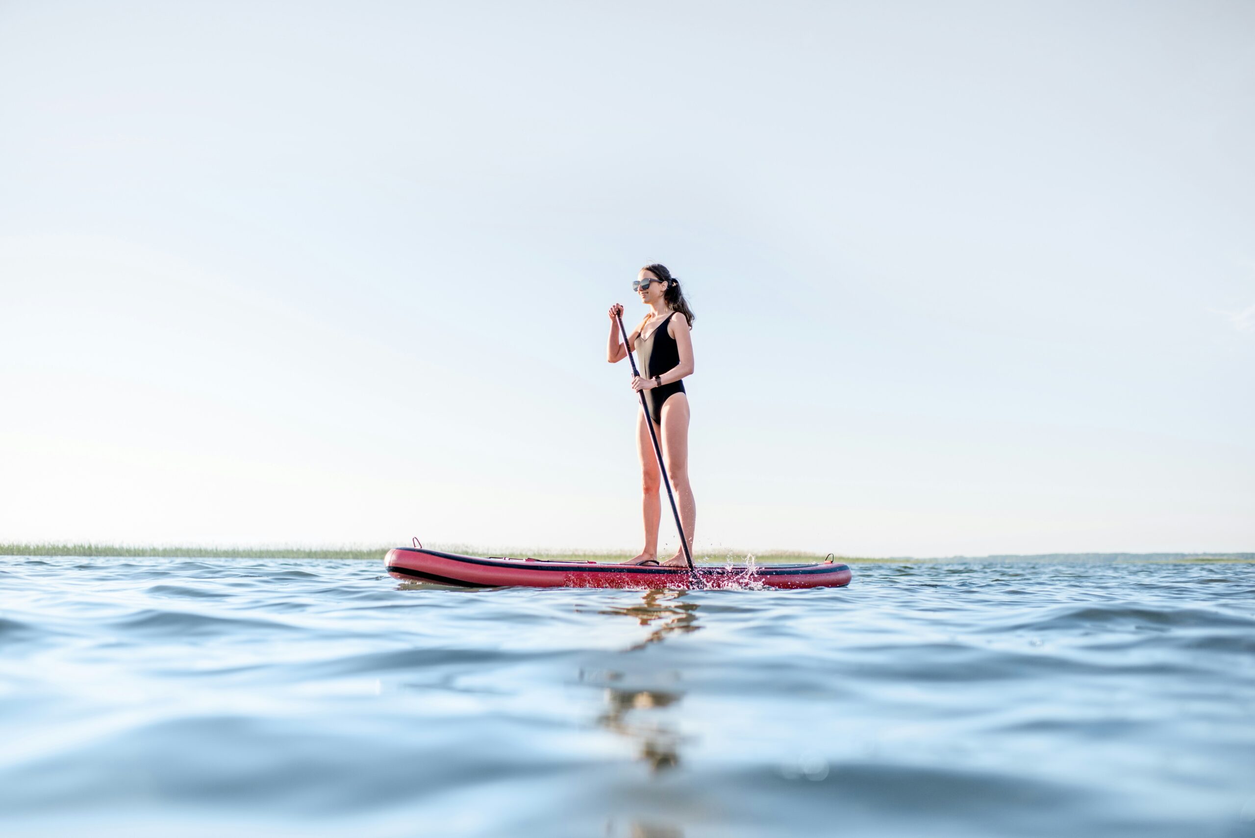 A woman paddle boarding