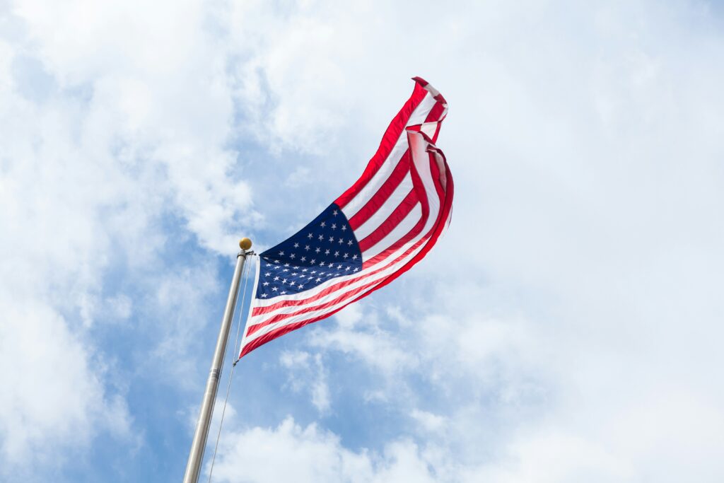 An American flag against a blue sky