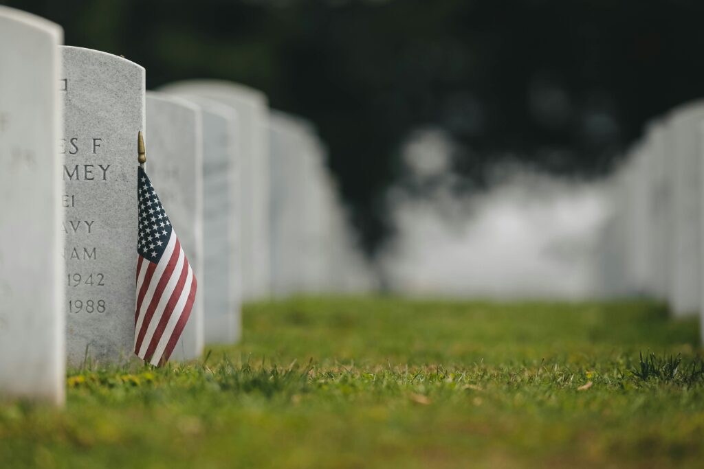 An American flag next to a headstone