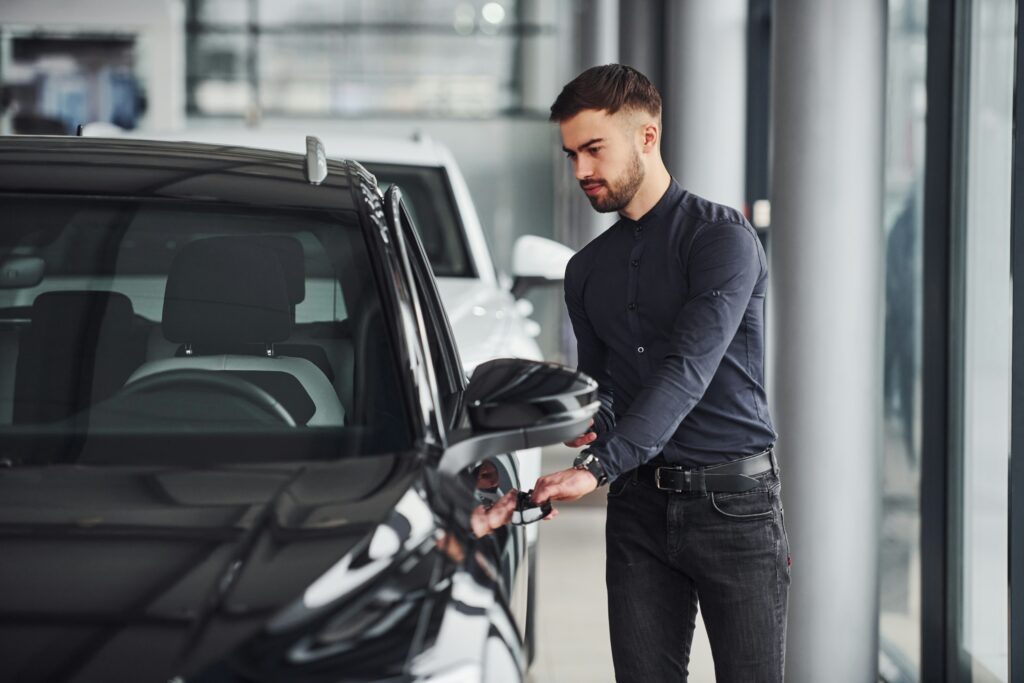 A man opening the door of a car