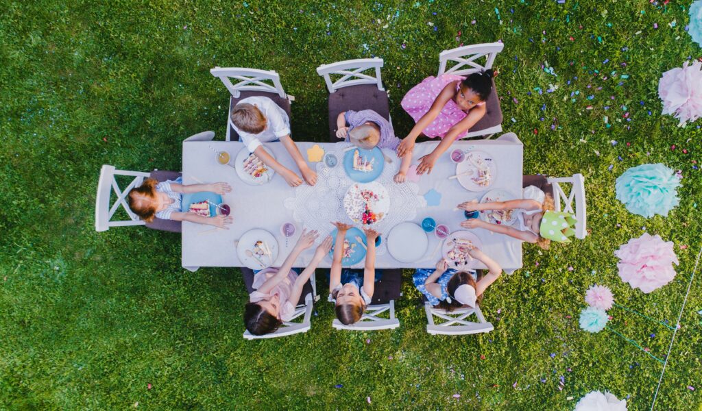 Children at a table full of party food