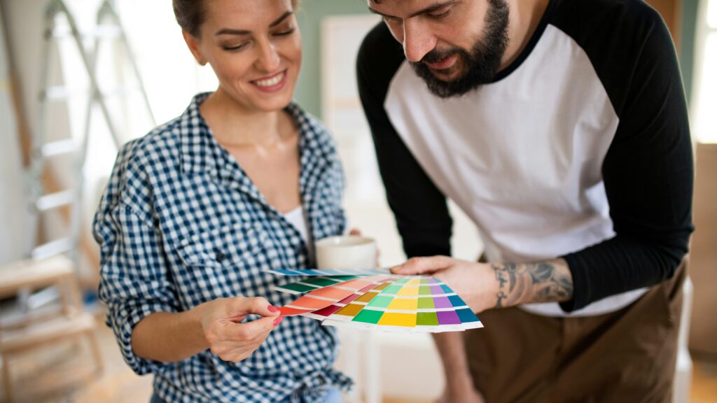 Two interior designers looking at paint swatches