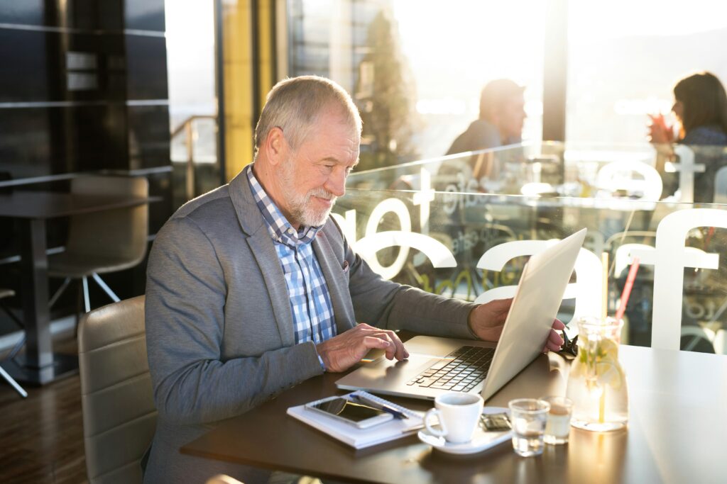 A man reading important documents on a laptop