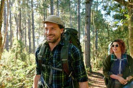 Two people hiking through a forest