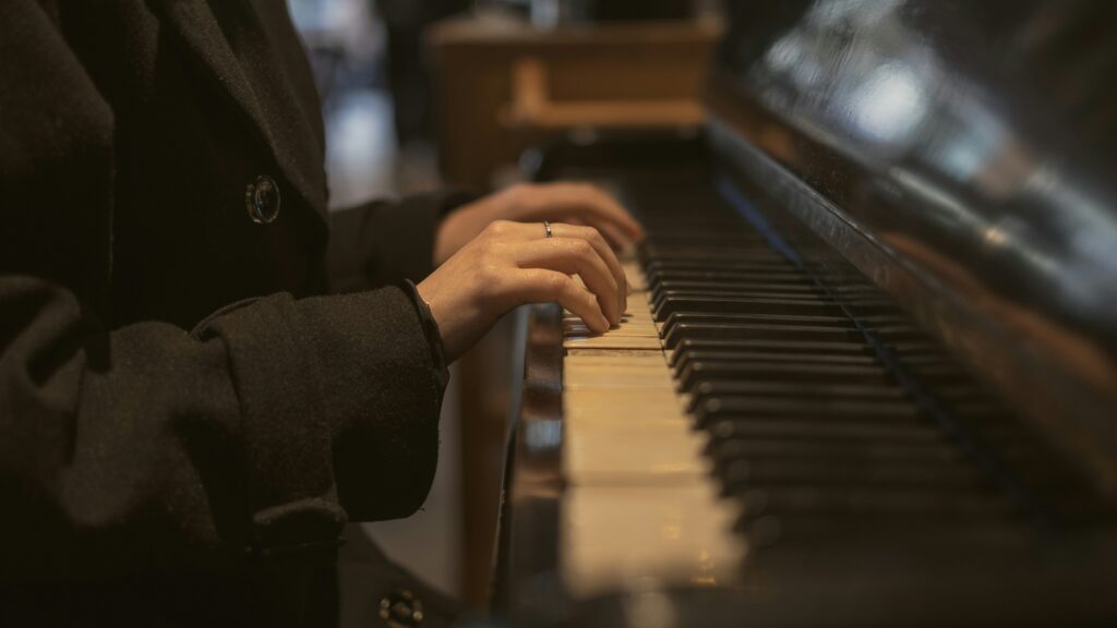 Hands playing a piano