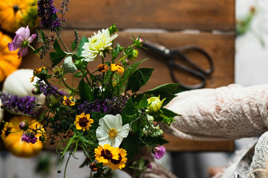 A person arranging yellow flowers