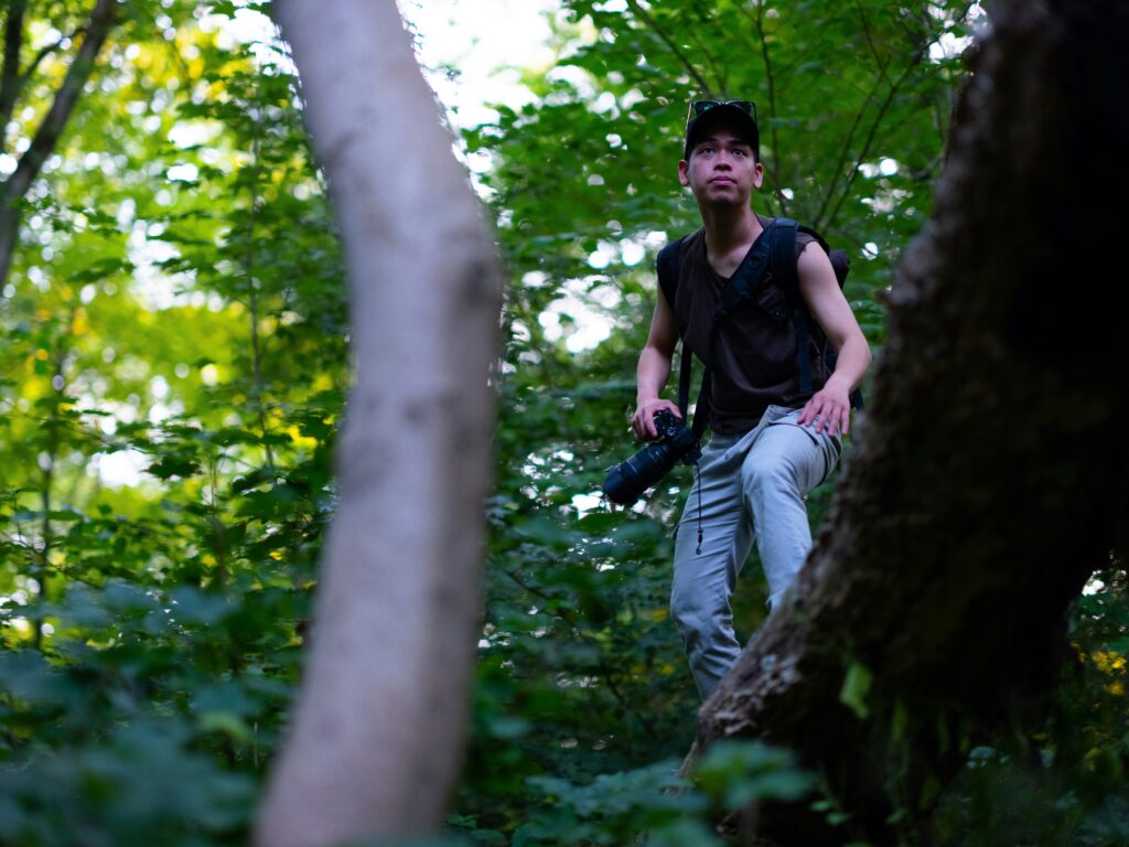 A photographer surrounded by trees