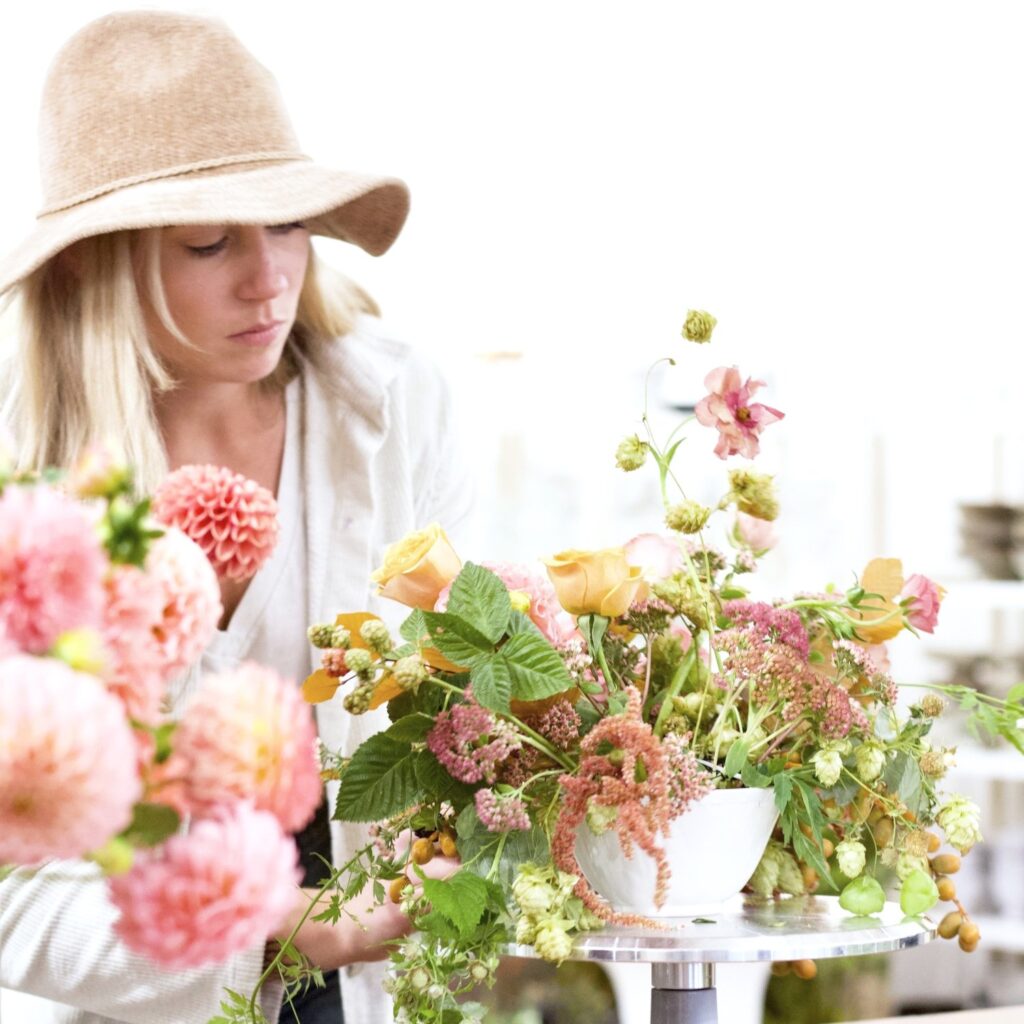 A florist arranging flowers from Unbound Floral Design