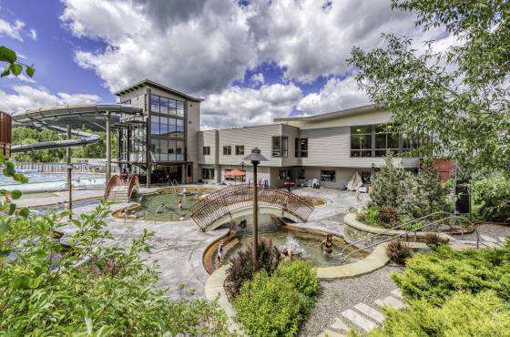 Old Town Hot Springs building with walkways, pools and a water slide. One of the great Fall family activities in Steamboat Springs.