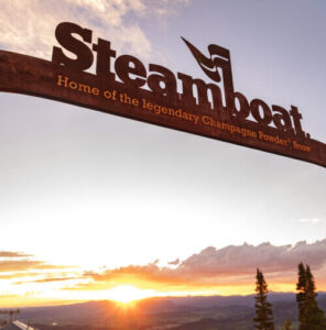 Steamboat words on a large metal sign at Thunderhead Lodge, overlooking the sunset on Mt. Werner