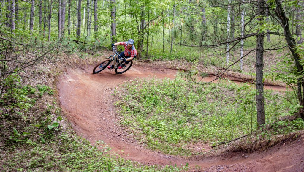 Biker riding a curved trail for mountain biking in Steamboat Springs