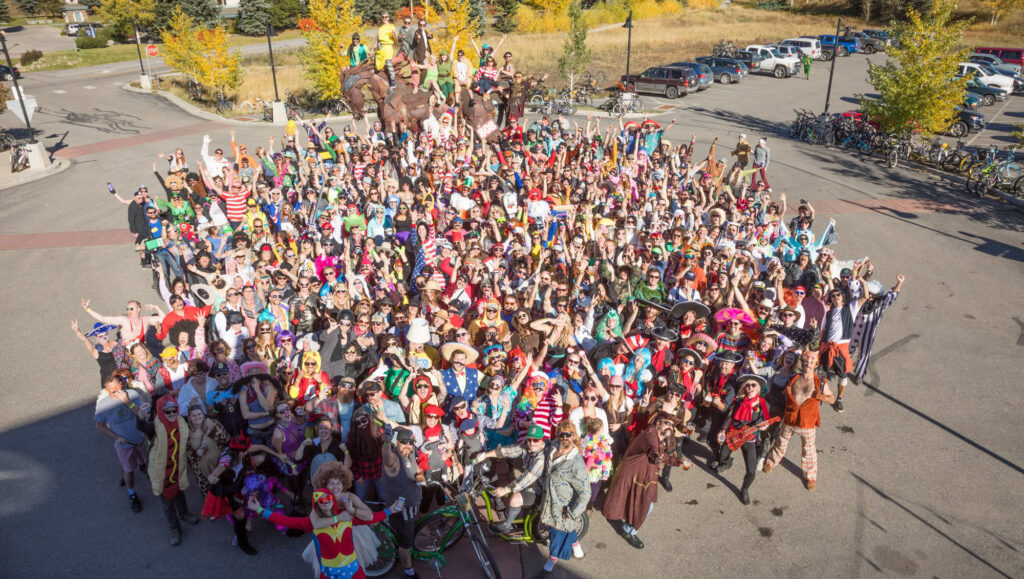 A large group dressed in costumes, all have mustaches on for the annual Steamboat Springs Mustache Ride. 