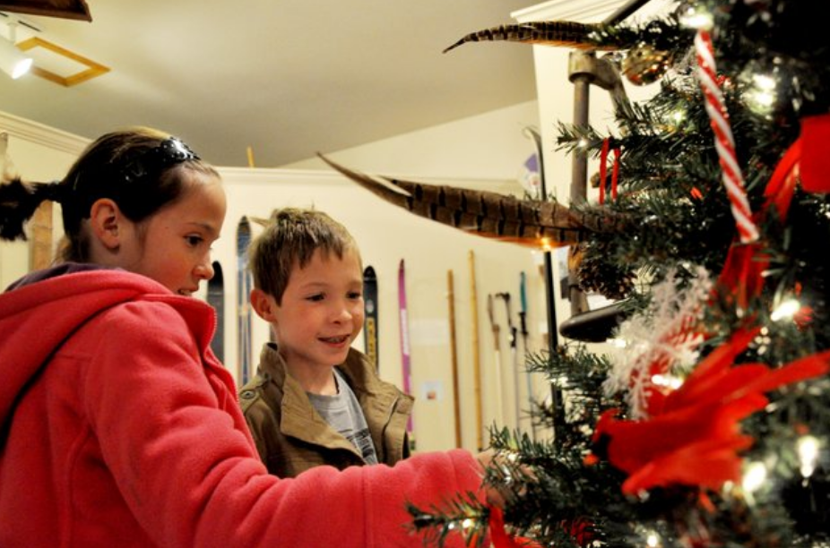 A young boy and girl admire a decorated Christmas tree at the Festival of Trees, an annual event in November in Steamboat Springs