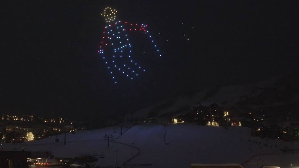 Drones forming the image of a cowboy skiing in the night sky. 