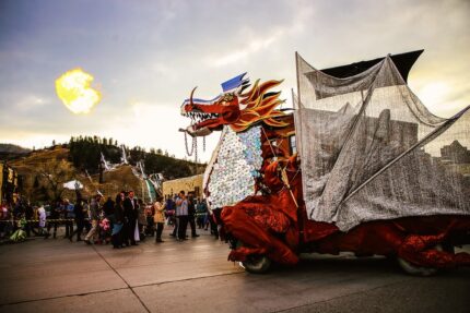 The Fire Breathing Dragon is bright red and towers over spectators at the Halloween Stroll in downtown Steamboat.