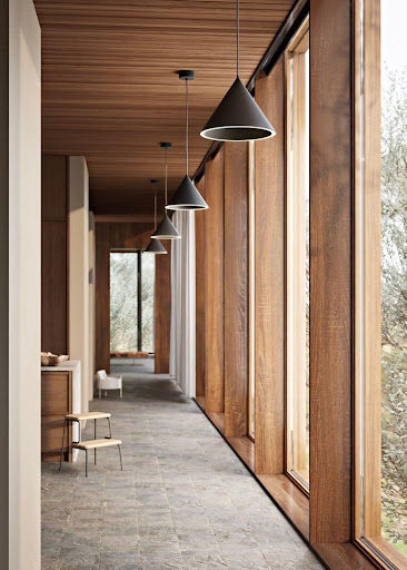 Warm wood corridor with black pendant lights and floor-to-ceiling windows, reflecting Haven’s calm soft modern style.