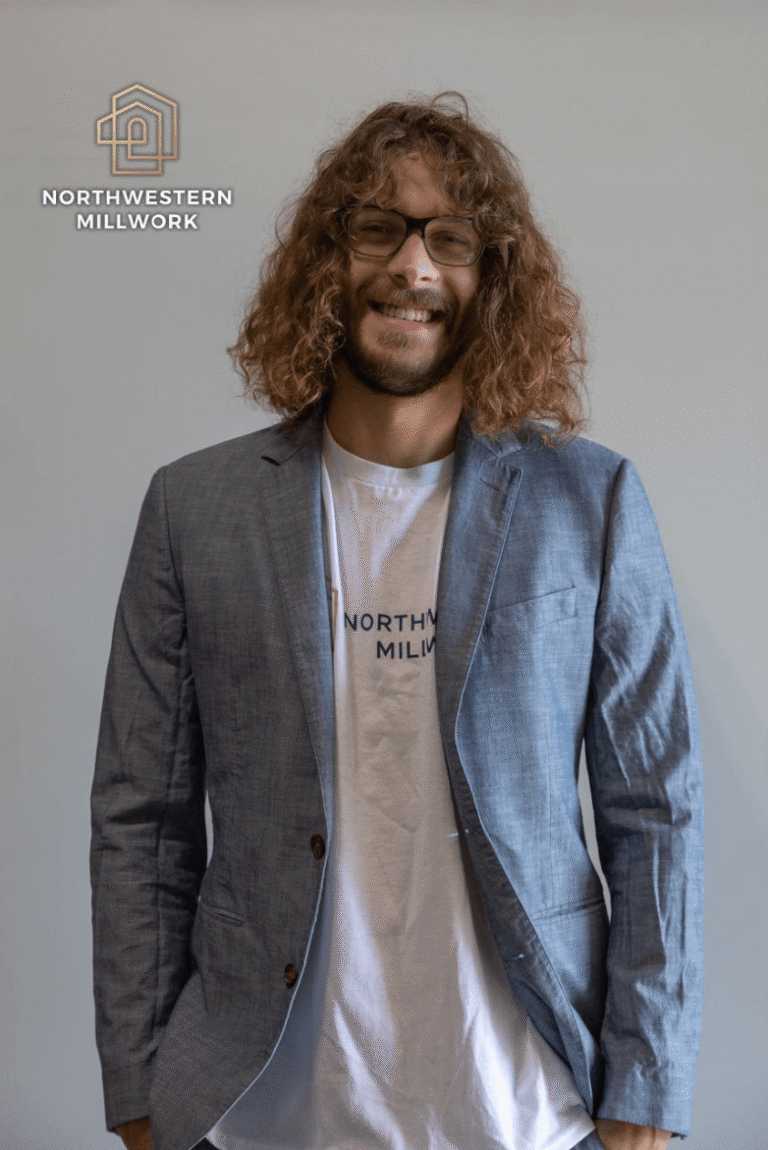 Portrait of Carter Sherman, Technology Manager at Northwestern Millwork, wearing a blazer and smiling.