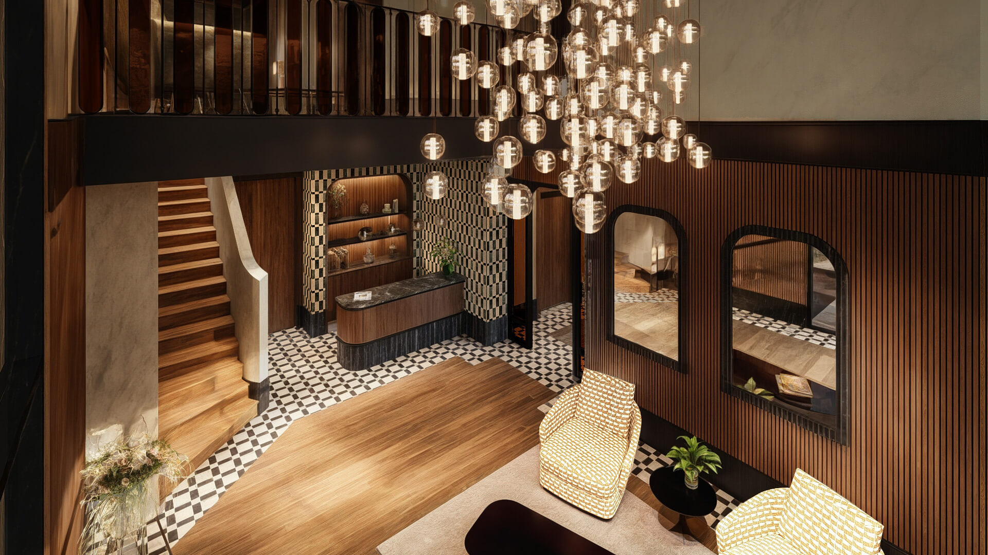 Interior lobby at The Astrid featuring a modern staircase, marble reception desk, warm wood finishes, and a chandelier of hanging globe lights.