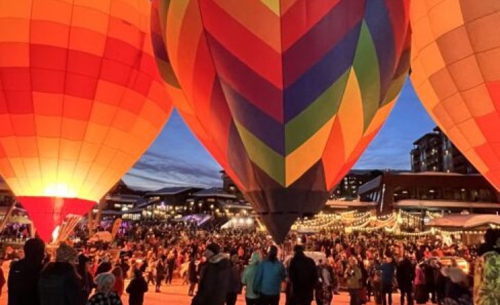 People in the Mountain Village walking among glowing hot air balloons.