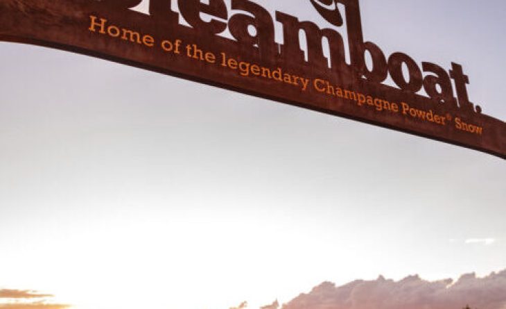 Steamboat words on a large metal sign at Thunderhead Lodge, overlooking the sunset on Mt. Werner